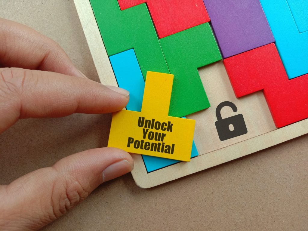 Variety of blocks and padlocks stacked and arranged on a tabletop with Unlock your potential message